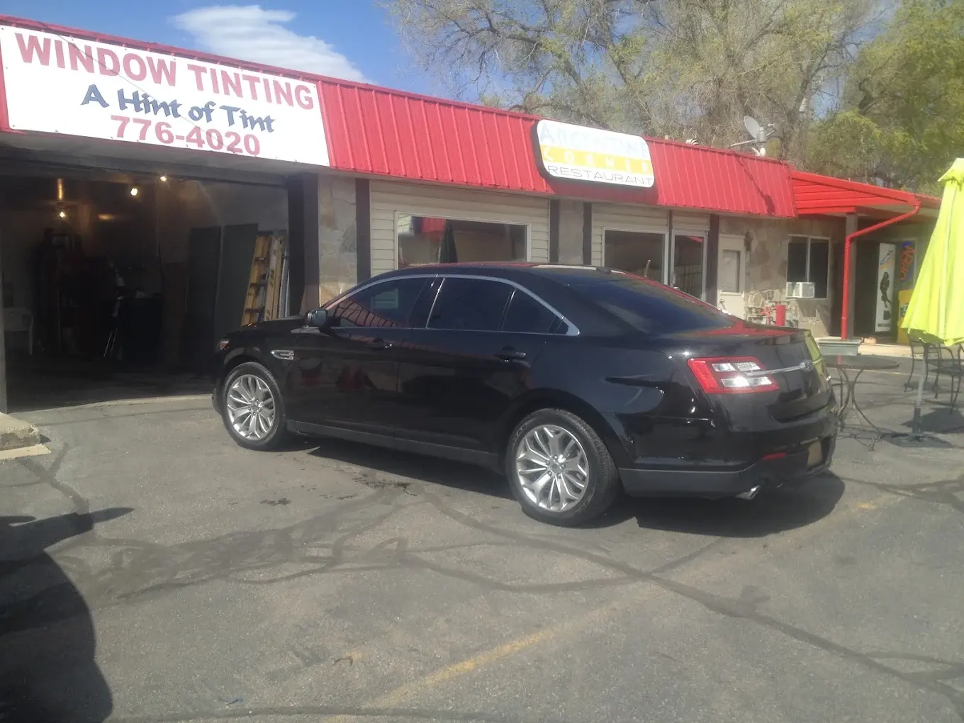Black Ford Taurus with tinted windows