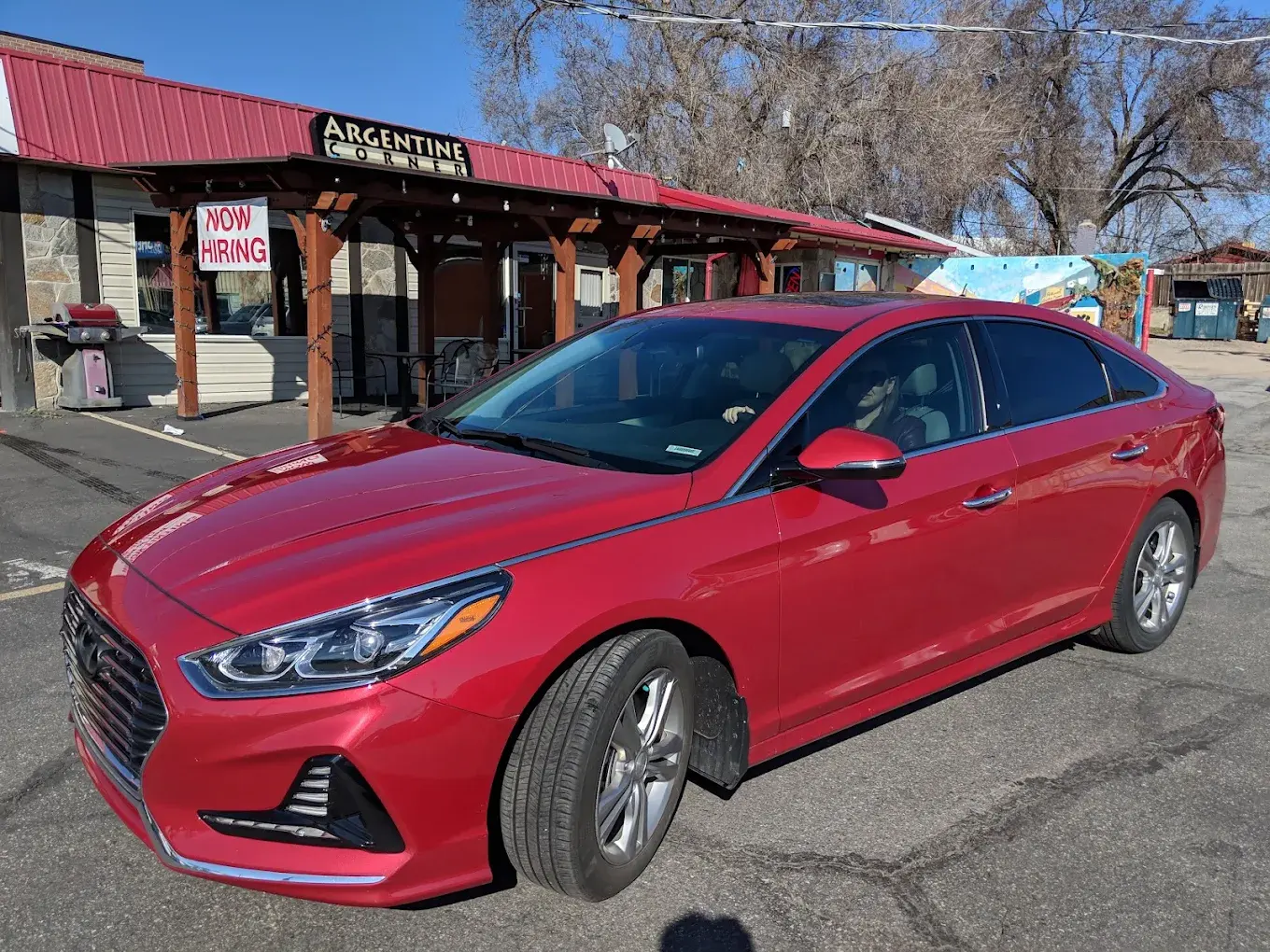 Red Hyundai Sonata with tinted windows