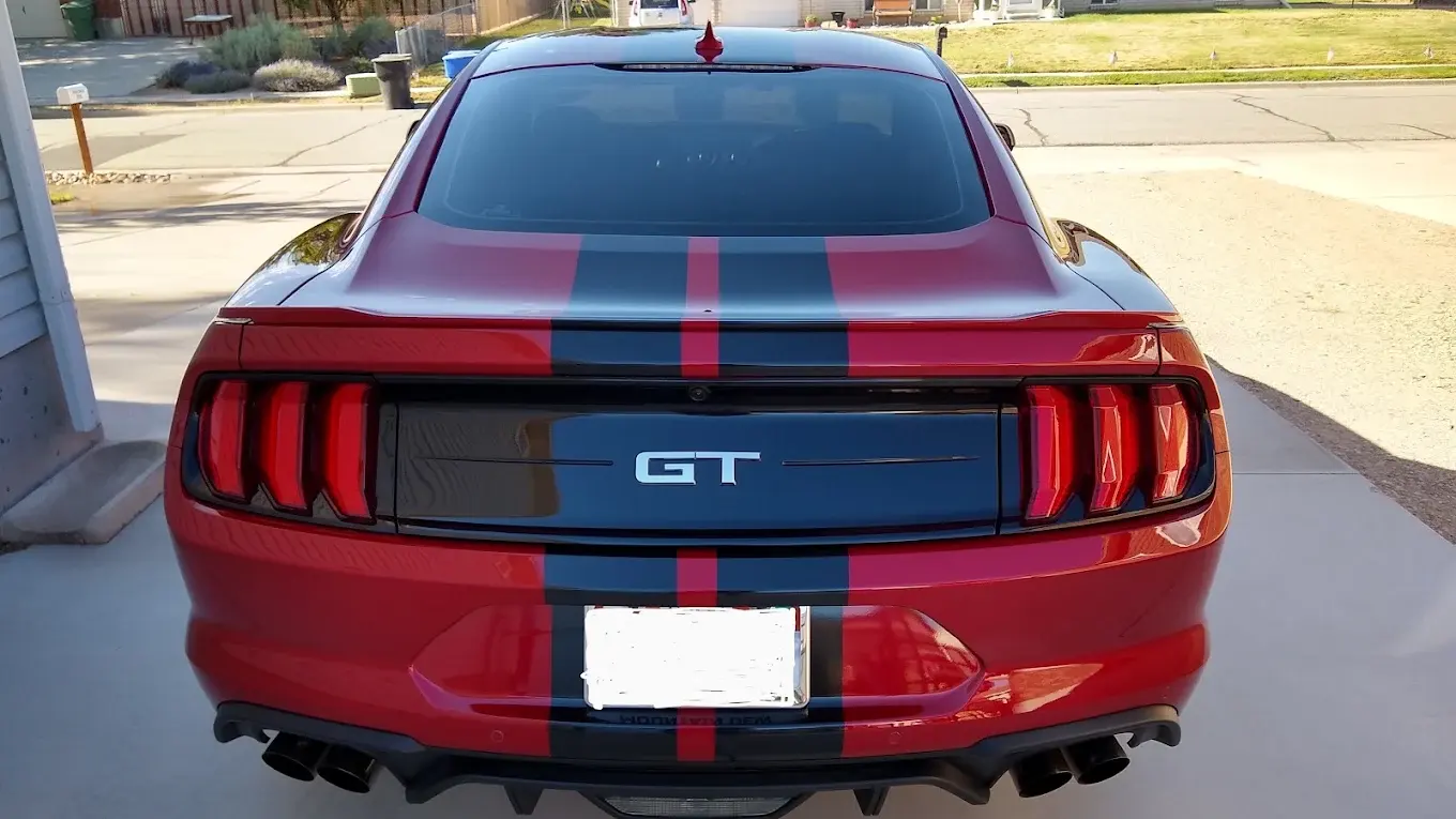 Red Ford Mustang GT with a tinted rear window