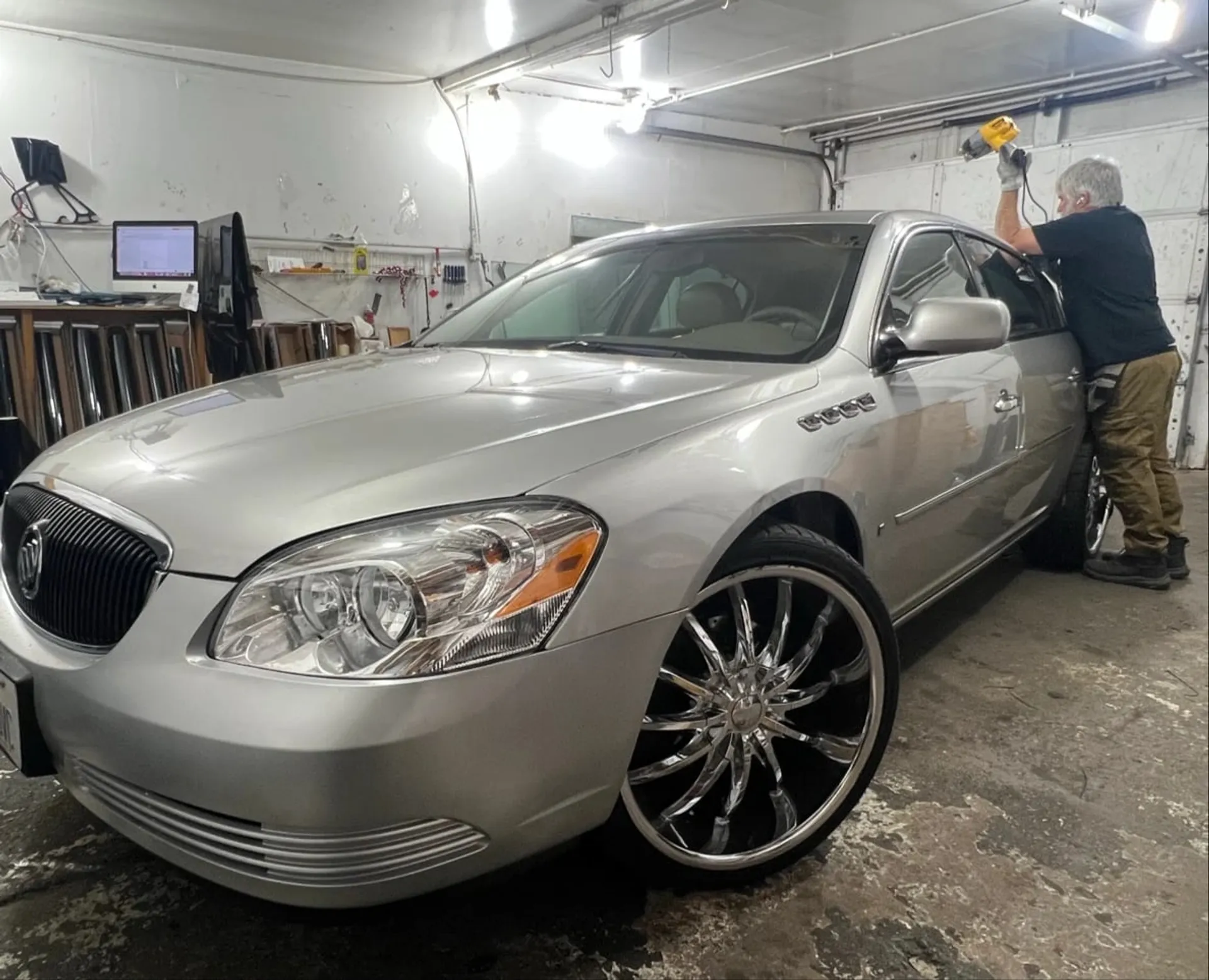 Window film being installed on a car at A Hint of Tint in Clearfield, UT
